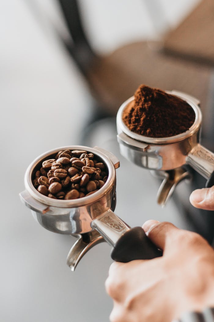 Detailed view of portafilter holding coffee beans and grounds, ideal for caffeine enthusiasts.